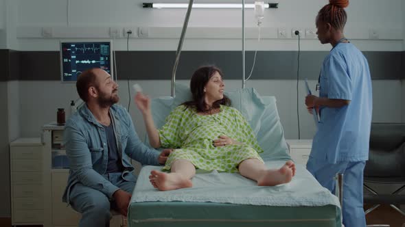 Caucasian Couple Expecting Child in Hospital Ward alt