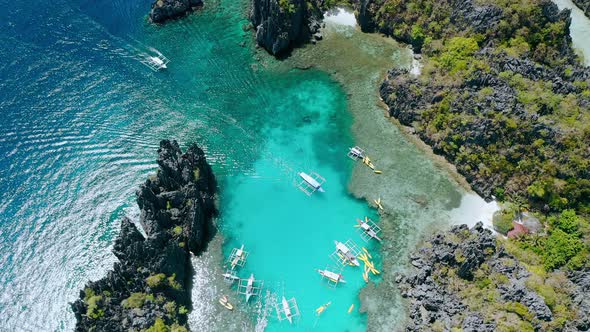 Aerial Top Down View of Tourist Boat Arriving Into the Small Lagoon in ElNido Tour A Palawan alt