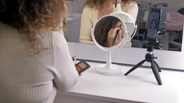 Wellgroomed Middleaged Beauty Blogger Talks About Makeup Techniques alt