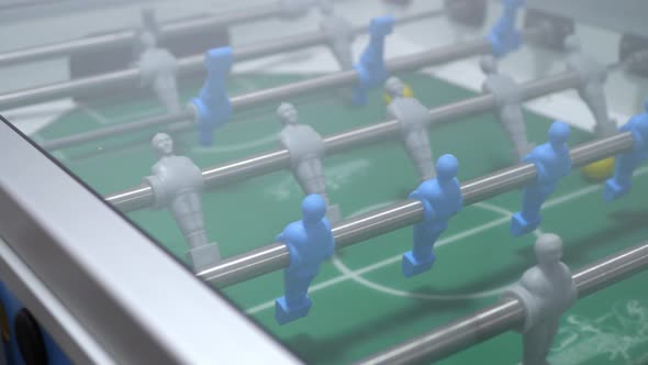 Man plays foosball on vacation with friends. Table football.