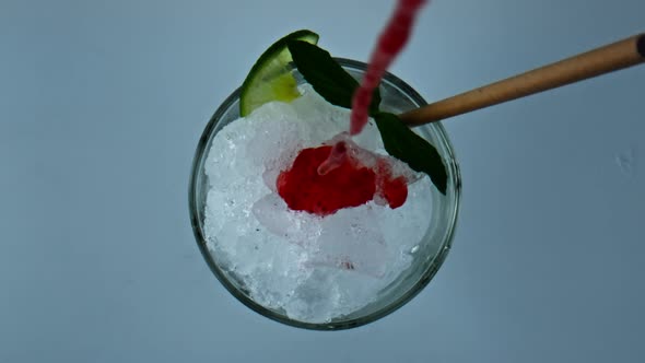 Pouring Iced Strawberry Cocktail Jam in Glass Closeup alt