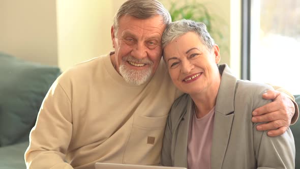 Close Portrait of Smiling Elderly Husband and Wife Looking at Camera alt