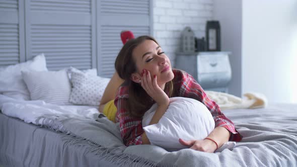 Cheerful Smiling Pretty Woman Relaxing on Bed alt