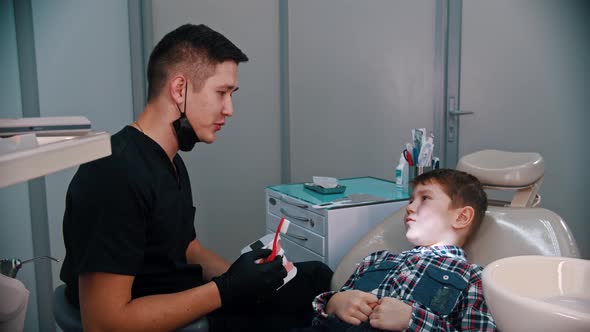A Little Boy Having a Treatment in the Modern Dentistry - Talking About the Hygiene and Brushing alt