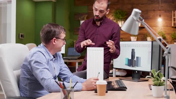 Two Architects in Cozy Office Talking About New Buildings Architecture alt