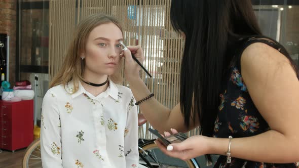 the Make-Up Stylist Doing a Make-Up to Hipster Model alt