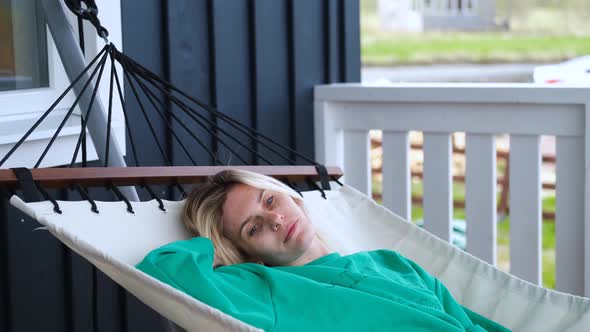 portrait woman resting lying in a hammock