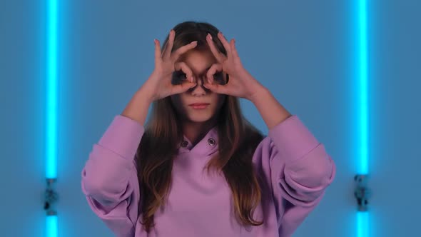 Portrait of Young Cute Woman Smiling and Making Sign Ok alt