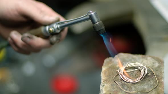 The Jeweler Melts the Silver Wire alt