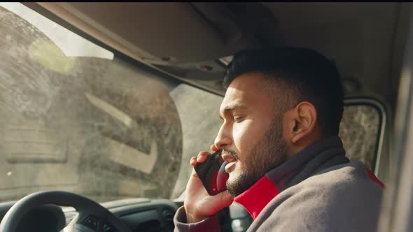 Indian Man Sitting in the Van and Having Phone Conversation alt