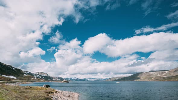 Oppland, Tyin Lake, Norway, Stones On Coast Of Beautiful Lake Tyin In Summer Day, Norwegian Nature.  alt