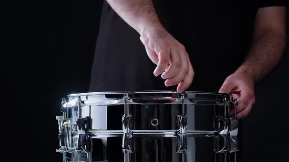 Man Preparing Drums Closeup alt