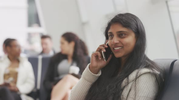 Woman talking on cell phone at airport