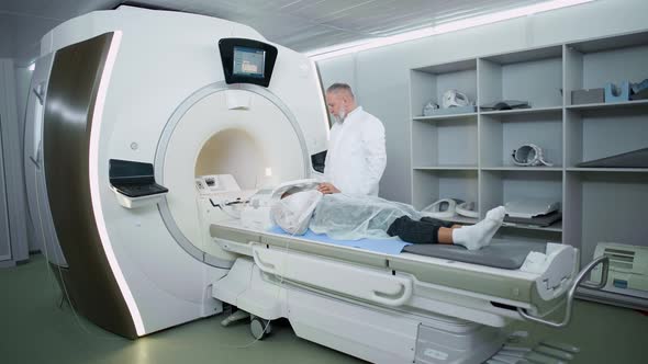 Magnetic Resonance Imaging in the Modern Hospital Adult Man Doctor Performs a Magnetic Tomographic alt