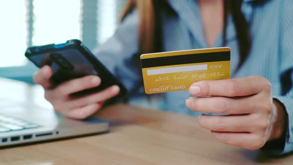Woman customer hands holding credit card and smartphone for online shopping