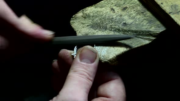 Closeup of Wedding Ring Polishing By Caicasian Jeweler Isolated  Footage alt