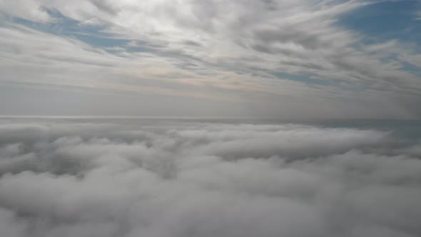 Flying Over Gray Clouds. Bad Weather in the City