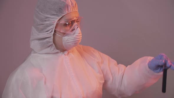 Protected Scientist Pouring Liquid in a Laboratory. Research and Science Concept alt