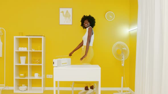 African Woman Has Fun In Yellow Office alt