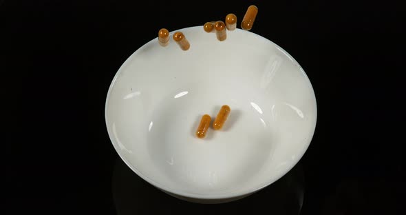 Turmeric, Turmeric Longa, Capsules Falling on Black Background, Indian Spice, Slow Motion 4K alt