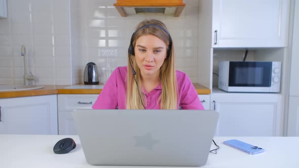 Helpdesk operator woman working from home. Distant tech support specialist wearing headset in 4k alt