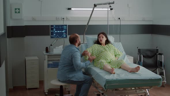 Pregnant Woman with Painful Contractions in Hospital Ward alt
