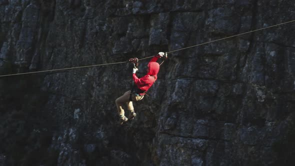 Young Caucasian man zip lining alt