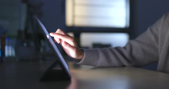 Typing on Tablet Computer at Night alt
