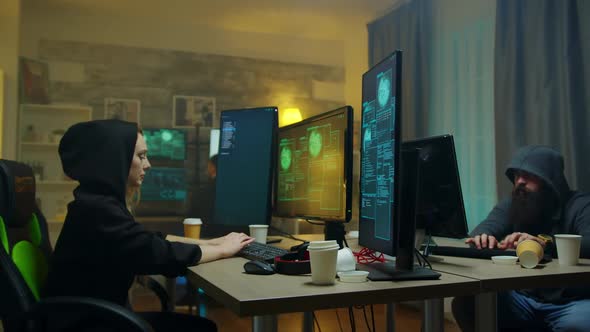Male Hackers Looking at How Their Cyber Criminal Girl alt
