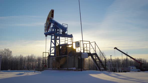 Oil Production Plant Is Pumping Petroleum From Ground in Winter Day, Huge Industrial Equipment alt