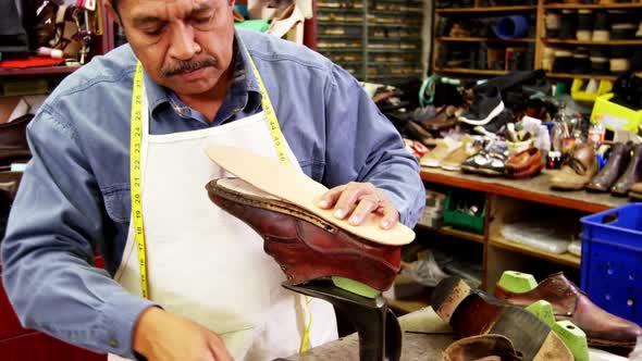Cobbler working on shoe sole alt