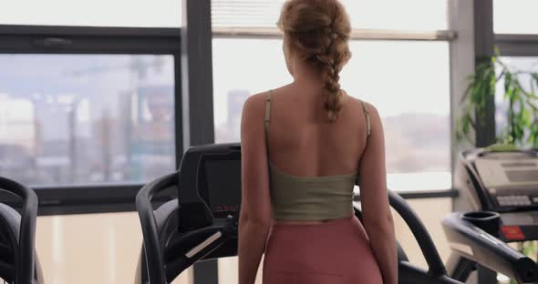 Woman Walking on a Treadmill in Gym