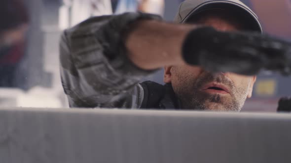 Male Employee Blowing Off Polymer Plastic Dust alt