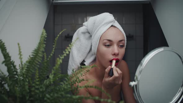 Young Woman Applying Lipstick