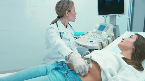 Doctor and patient looking at screen during ultrasound examination