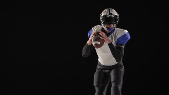 American Football Player Wearing Uniform Pads and Helmet Throws the Ball and Scores a Goal alt