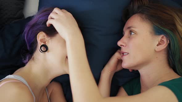 Top View of Two Young Women Laying in Bed Caress and Stroke alt