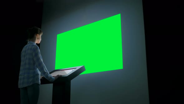 Green Screen Chroma Key Concept - Woman Looking at Empty Large Wall Display