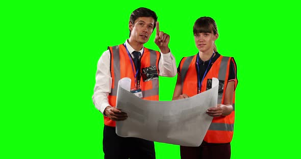 Front view of a site workers looking at a site map with green screen alt