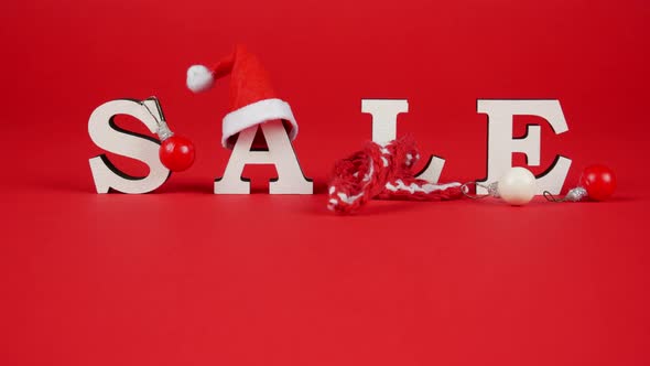 White Letters SALE Decorated with Christmas Hat, Warm Scarf and Tree Ball. Stop Motion alt