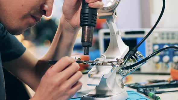 Engineer Is Observing Microcircuits Under a Magnifier alt