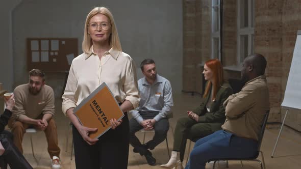 Portrait of Female Psychologist at Mental Health Support Group Meeting alt