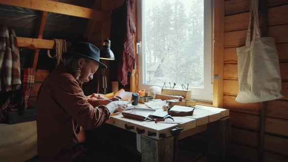 Craftsman Using Hammer for Leather Work alt