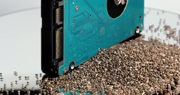 On a Rotating Table is a Hard Drive and a Pile of Chia Seeds alt