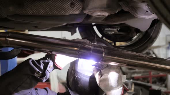 Welding Process. Worker Doing Welding Job. A Man In Helmet Doing Argon Welding Parts alt