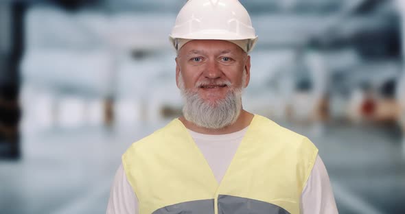 Portrait of a Male Builder, Adult Gray-haired Man Looks at the Camera, Worker Man in the Outfit, a alt