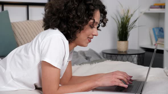Smiling Hispanic Curly Woman Student Study Uses Laptop Distance Education alt