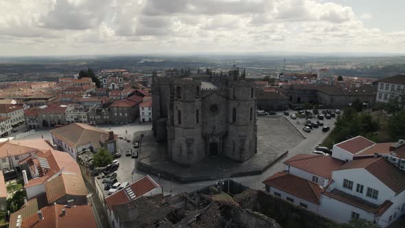 Aerial view of Guarda Cathedral portuguese landmark facade, orbital drone shot