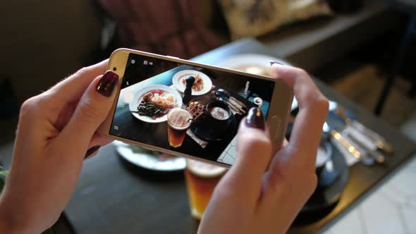 Female Hands Photographing Food By Smartphone alt