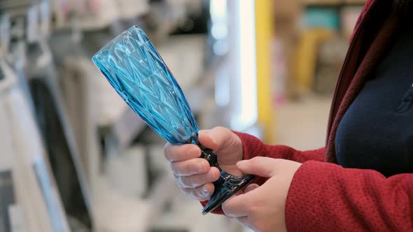 Women Hands Choose Blue, Glass Wine Glass in Supermarket